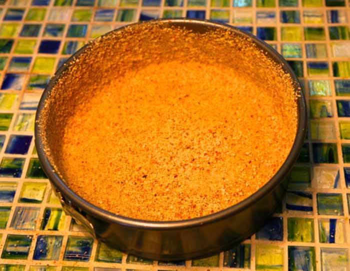 Press the almond mixture onto the bottom and up the greased sides.