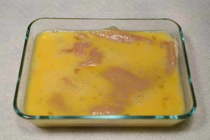 Dip each chicken breast in the egg, then press into the parmesan breading.