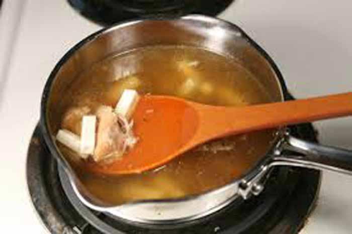 For the soup, combine 2 cups of broth, about 1/2 cup of turkey meat, and the sliced tofu in a saucepan.