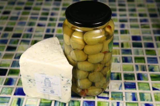 Pour out half the reserved brine, top the jar up with olive oil, and pour it back over the olives.