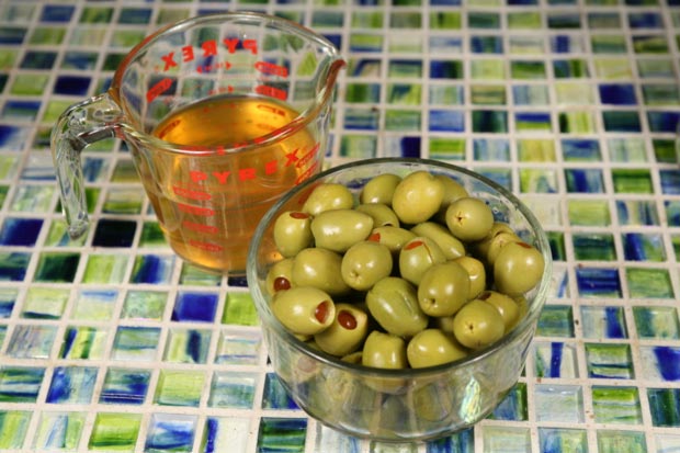 Pour the olive brine into a measuring cup and reserve it for later.