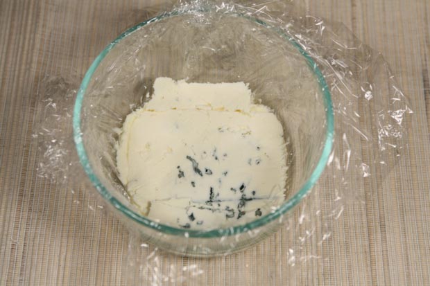 Top with a 1/4-inch slice of blue cheese. A wire cheese cutter slices it cleanly, since blue cheese crumbles easily.