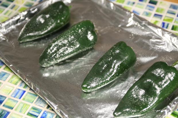 Place the chiles on a baking sheet and char them under a high broiler. A light spray of oil speeds up the blistering.