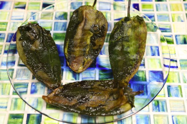Peel the skin off the chiles. Do not rinse them under water.