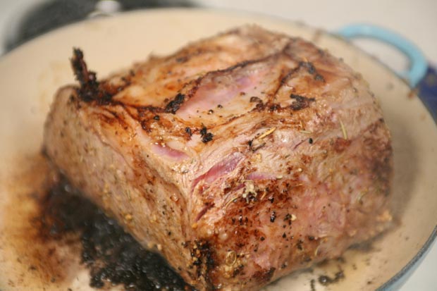 In a large saute pan, sear all sides of the roast over high heat to build a crust.